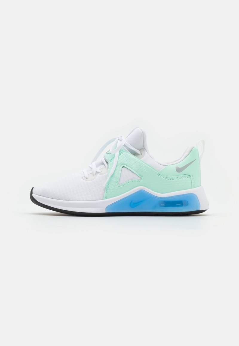 White athletic shoe with mint green accents, mesh upper, rubber sole, and visible air cushioning; features triangular cutouts and curved design.