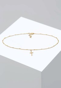 Kultainen ketjun kaulakoru, jossa on pieniä pallomaisia korostuksia ja keskellä ristikoru. Sileä pinta, kevyt muotoilu ja säädettävä lukko.