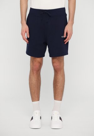 Navy blue cotton shorts with an elastic waistband, drawstring, and rolled hem. Features a small embroidered logo on the left leg.