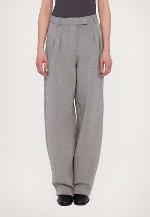 Gray wide-leg trousers made of soft fabric, featuring front pleats and a comfortable elastic waistband. Paired with black footwear.