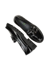 Zwarte leren schoenen met een glanzende afwerking, voorzien van een decoratieve gesp en een dikke, gestructureerde rubberen zool voor grip en stabiliteit.