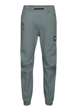 Lichtgrijze sportbroek van ademend materiaal, met een elastische tailleband, taps toelopende pijpen en zijzakken met rits.