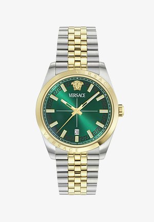 Luksuzni ručni sat sa zelenim brojčanikom, narukvicom od zlata i srebra, zlatnim oznakama sati, logotipom Meduza i prikazom datuma na 6 sati.