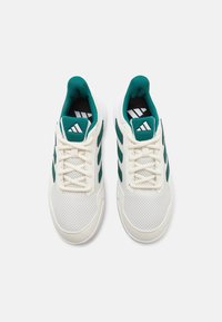 Zapatillas deportivas blancas con rayas verdes, parte superior de malla, punta redonda, diseño de cordones, collar acolchado y logotipo en la lengua. Suela de goma.