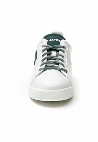White sneaker with a smooth leather upper, green textile accents, contrasting white laces, and a rubber sole featuring a textured grip.