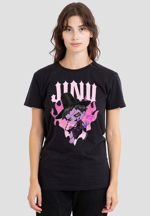 Black cotton t-shirt featuring a purple cartoon character in a witch hat, surrounded by pink flames, with "JUNO" text in bold above.
