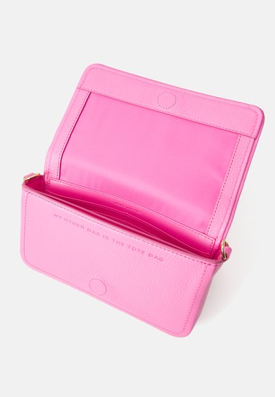 Pink leather handbag with a textured exterior. Features a magnetic closure and an interior zip pocket. Text reads: "MY OTHER BAG IS THE TOTE BAG."