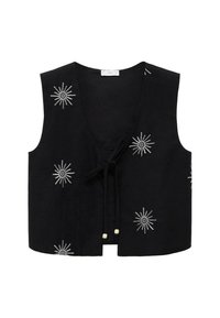 Musta hihaton liivi, jossa on brodeerattuja valkoisia tähtisateen muotoisia kuvioita. Siinä on V-pääntie ja edessä solmittava nauha, jossa on puuhelmiä.