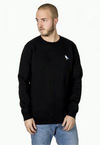 Black sweatshirt in cotton blend, features a round neck, ribbed cuffs, and a small embroidered bird logo in white and blue on the chest.