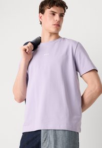 Kurzarm-Lavendel-T-Shirt aus weichem Stoff, mit Rundhalsausschnitt und minimalem weißen "BOSS"-Logo auf der Brust. Lässige Passform.