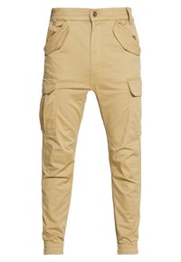 Beiga cargobyxor i bomull, med två sidfickor, två sidocargofickor och ett elastiskt midjeband med muddar vid anklarna.