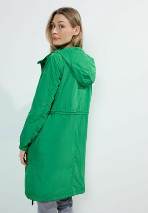 Zelená lehká bunda s kapucí, stahovaným pasem a elastickými manžetami. Hladká textura, volná délka a minimalistický design.