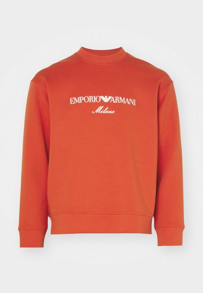 Oranžové sako s vysokým golierom, dlhými rukávmi a bielym logom "EMPORIO ARMANI Milano" na hrudi. Hladká textúra.