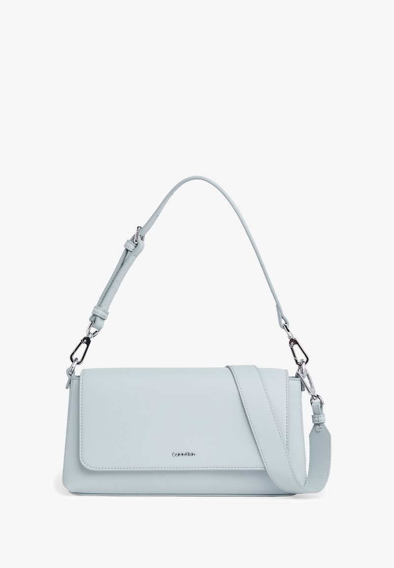 Light blue leather handbag with a flap closure, adjustable strap, silver hardware, and a minimalist design featuring a logo at the front.