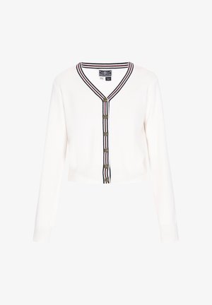Cardigan blanc court avec manches longues, rayures bleu marine et rouge le long de l'encolure en V et du plastron à boutons, et six boutons dorés.