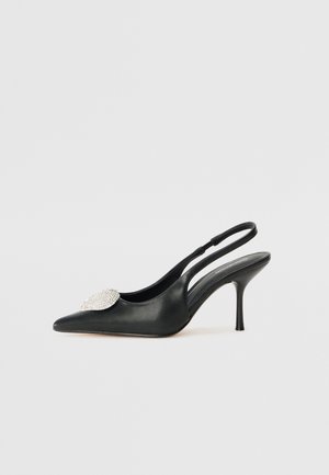 Black leather slingback shoe with a pointed toe, featuring a decorative rhinestone accent on the vamp and a slender stiletto heel.
