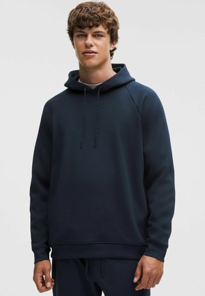 Marineblaue Kapuzenpullover aus strukturiertem, glattem Stoff, mit Kordelzug und gerippten Bündchen an Ärmeln und Saum. Raglanärmel für bequemen Sitz.