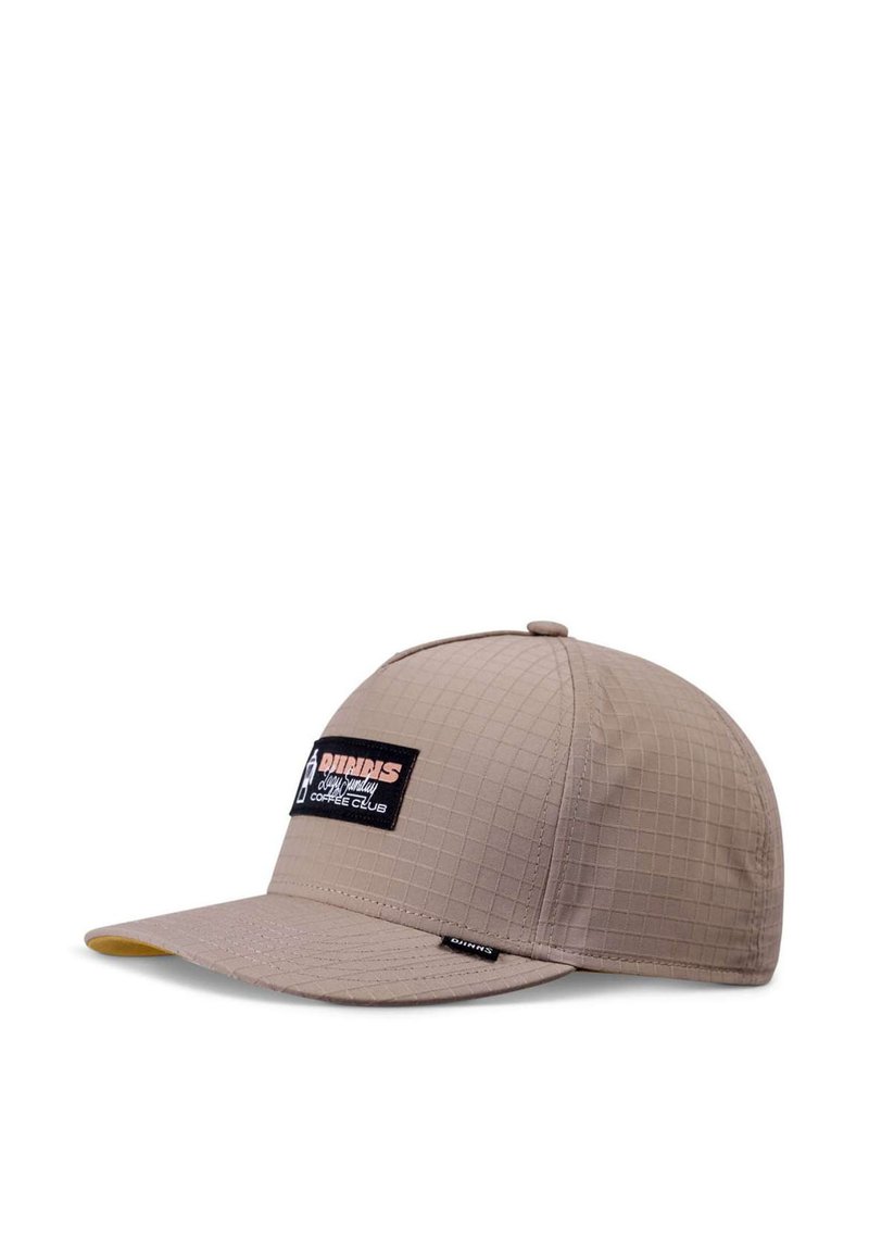 Beige cap with a checkered texture, flat brim, and a black logo patch featuring white and red text on the front left side.