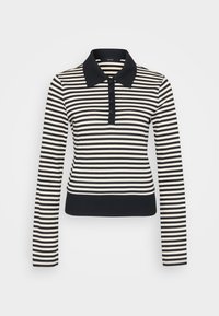Striped langermet polo skjorte i krem og marineblå, med kragehals, knappelukking og ribbede mansjetter og nederkant.