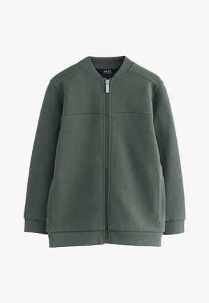 Temno zelena jopica z zadrgo, z rebrastim ovratnikom, manšetami in spodnjim robom, z bočnimi žepi in teksturiranim vzorcem tkanine.