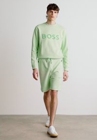 BOSS HEADLO - Spodnji deli trenirk - open green