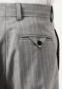 Gray striped trousers made of textured fabric, featuring a flat front and a single buttoned pocket with a triangular flap detail.