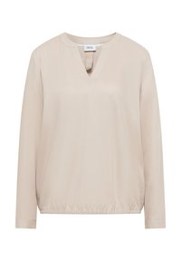 Haut beige à manches longues avec col en V, ourlet élastiqué et texture lisse. Étiquette indiquant "CECIL". Design simple sans motifs ni accents.