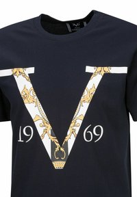 Marineblaues T-Shirt aus Baumwolle, mit einem großen weißen und goldenen "V"-Design mit komplizierten Details und dem Jahr "1969" darunter in Weiß.