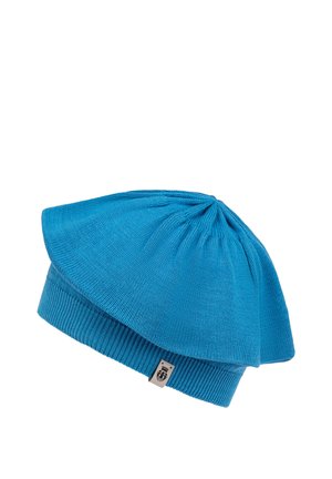 Blue knit hat with a flared top and ribbed cuff. Features smooth texture, intricate stitching, and a small branded tag on the side.
