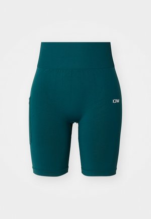 Teal idrettsshorts laget av elastisk stoff. Høy midje og sidelomme. Enkelt design med lite hvitt logo foran.
