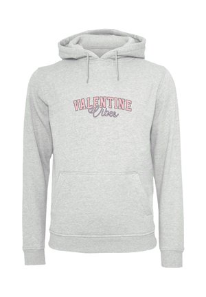 Light gray hoodie with front pocket and pink text "VALENTINE Vibes" in block and script fonts.