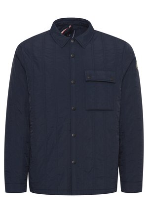 Navy quilted jacket featuring a button-up front, collar, and a single chest pocket with snap closure. Textured fabric and horizontal stitching.