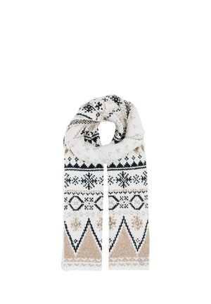 Young woman wearing a black puffer jacket, white knit sweater, blue jeans, and a long patterned beige and black scarf.