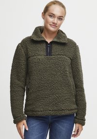 Fleece pullover in donkergroen, met een hoge kraag, ritssluiting en een gestructureerd oppervlak. Zacht stof met een gezellige uitstraling.