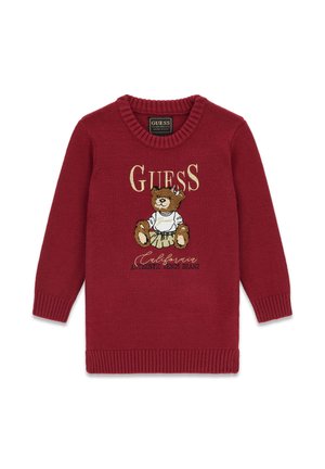 Pull rouge pour enfants avec col et poignets côtelés, représentant un ours en peluche portant une jupe et le texte "Guess California Authentic Denim Brand."