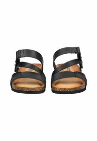 Sandali in pelle nera con cinturini incrociati, fibbia regolabile, soletta in sughero e suola piatta in gomma. Progettati per comfort e supporto.
