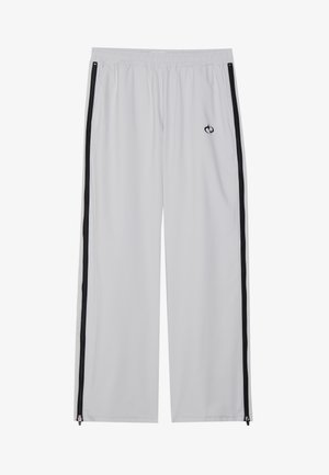 Világosszürke sportnadrág, elasztikus derekkal, fekete oldalcsíkokkal és cipzárokkal a bokáknál, sima, rugalmas anyagból készítve.