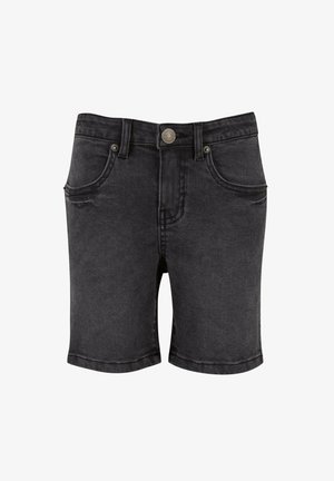 Fekete farmer sort klasszikus öt zsebes kialakítással, ezüst színű kiegészítőkkel és rojtos szegéllyel. Az anyag enyhén kopott textúrával rendelkezik.