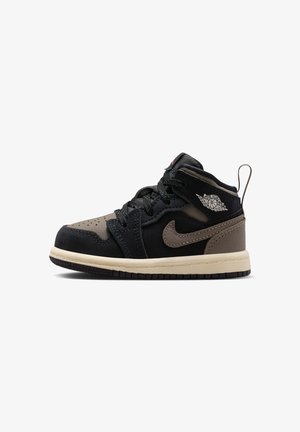 Zwartbruine Air Jordan mid-top sneaker met Nike swoosh, wings-logo, zwarte veters en beige zool, naar rechts gericht op een witte achtergrond.