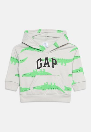 Felpa con cappuccio per bambino piccolo color grigio chiaro con coccodrilli cartone animato verdi sparsi e logo "GAP" in bianco e nero sul davanti.