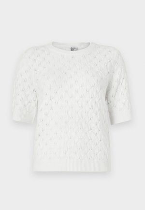 Balta īss piedurkņu adīta džempera ar pīņu rakstu, apaļu izgriezumu kaklam un ribotu apakšu. Izgatavota no viegla, teksturēta auduma.