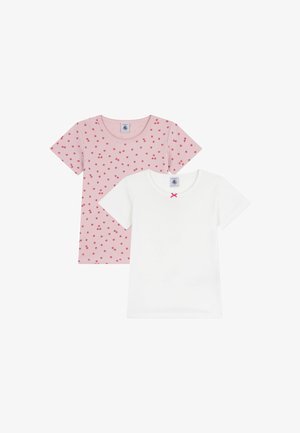 Two t-shirts: one pink with red dot pattern, the other white with a small pink bow at the neckline. Both are short-sleeved and cotton.
