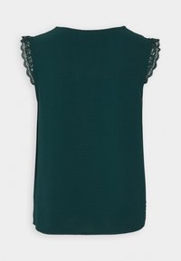 Dark teal sleeveless top featuring delicate lace trim on the shoulders, made from a soft fabric with a subtle textured finish.