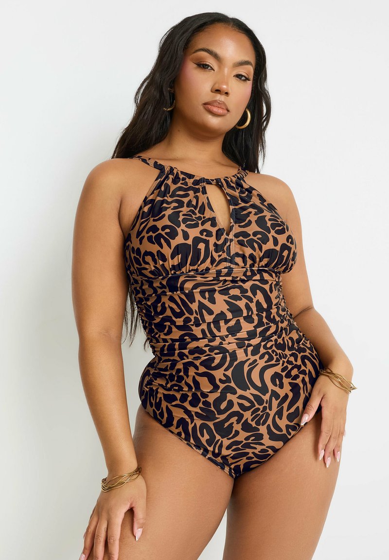 Yksiosainen leopardikuvioinen uimapuku, jossa on avainreiän muotoinen etuosa, kaula-aukko ja poimutettu yksityiskohta. Materiaali on joustavaa ja sileää.