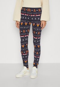 Marine leggings med et juleskjema som inkluderer pepperkakefigurer, sukkertøystenger, snøfnugg og teksten "God jul" i sterke farger.