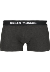 Graue Baumwoll-Boxershorts mit einem schwarzen Bund, auf dem "URBAN CLASSICS" in weißen Buchstaben angezeigt wird. Weicher Stoff, Länge bis zur Mitte des Oberschenkels.