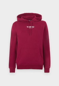 Sweat à capuche rouge avec poche kangourou à l'avant et logo "Tommy Jeans" imprimé en blanc sur la poitrine, avec capuche à cordon et poignets côtelés.