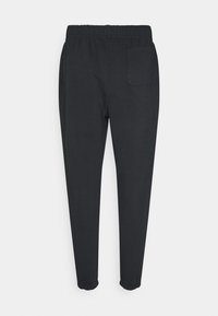 Czarne spodnie dresowe z elastycznym pasem, pojedynczą tylną kieszenią i dopasowanym krojem, wykonane z gładkiej bawełny.