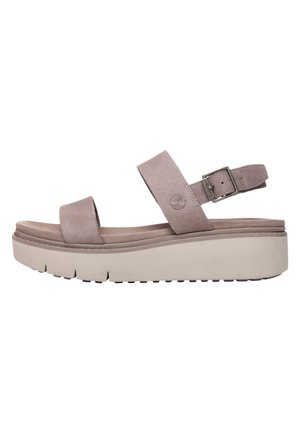 Hellviolette Wildleder-Plateau-Sandalen mit zwei breiten Riemen, einer verstellbaren Schnalle am Knöchel und einer dicken weißen Gummisohle mit strukturierten Rillen.