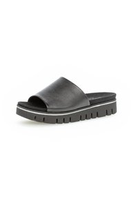 Zwarte leren slip-on sandaal met een brede band, open teen en een dikke, textuurgevoelige zool met groeven en een witte accentlijn.
